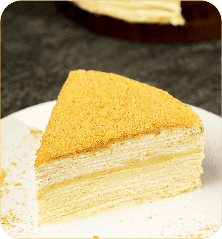 A slice of rich durian crepe cake made with SilkyGold puree.